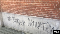 Graffiti on this Brussels refugee camp echoes the sentiments of many refugees and other migrants traveling from the Middle East and Africa to Europe. (Heather Murdock/VOA), 23 November, 2015. 