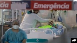Health workers treat a COVID-19 patient at the emergency unit of a field hospital set up to treat COVID patients in Ribeirao Pires, greater Sao Paulo area, Brazil, April 13, 2021.