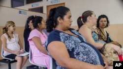 FILE - Women wait for prenatal exams at the National Hospital for Women in San Salvador, El Salvador, Jan. 29, 2016. Many fear infection by the Zika virus, which may be linked to neurological disorders in babies.