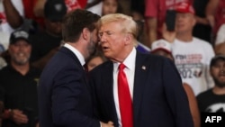 Former President and 2024 Republican presidential candidate Donald Trump shakes hands with Senator and 2024 Republican vice presidential candidate J.D. Vance as he arrives to speak at a campaign rally in Atlanta, Georgia, on Aug. 3, 2024.