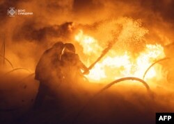 This handout photograph taken and released by Ukrainian State Emergency Service on Feb. 2, 2025, shows firefighters putting out a fire in the Eastern Ukraine Sumy region following a Russian strike.