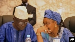 President of the electoral committee of Guinea Ben Sekou Sylla (L) speaks with president of the national transition council Rabiatou Sera Diallo during a meeting of political party leaders on the eve of presidential elections in Conakry (File Photo - 26 J