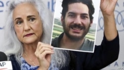 FILE - Debra Tice, mother of US journalist Austin Tice who was kidnapped in Syria five years prior, holds a dated portrait of him during a news conference in the Lebanese capital Beirut on July 20, 2017.