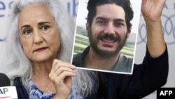 FILE - Debra Tice, mother of U.S. journalist Austin Tice who was kidnapped in Syria in 2012, holds a dated portrait of him during a press conference in the Lebanese capital Beirut on July 20, 2017. 