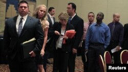People wait in line to meet with recruiters during a job fair in Melville, New York, July 19, 2012.