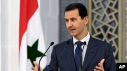Photo released by the official Facebook page of the Syrian Presidency shows President Bashar Assad addressing Syrian diplomats, in Damascus, Aug. 20, 2017. 