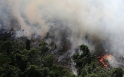 An aerial view of a tract of Amazon jungle burning as it is being cleared by loggers and farmers near the city of Novo Progresso, Para state, Brazil Sept. 23, 2013.
