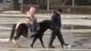 A child rides a pony in the main square of Kramatorsk, Ukraine.