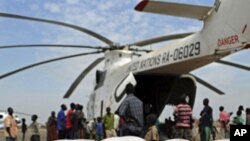 Relief food of the World Food Program is offloaded in Pibor, South Sudan, Jan 12, 2012.