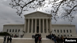 People wait in line outside the U.S. Supreme Court to hear the orders being issued, in Washington, March 18, 2019. 