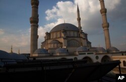 Solar panels, foreground, work on the roof of the Nizamiye Mosque in Midland Johannesburg, April 5, 2023.
