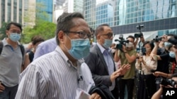 FILE - Albert Ho, center, arrives at a court in Hong Kong, May 17, 2021. 