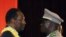 Mali's Interim President Dioncounda Traore, left, is congratulated by coup leader Amadou Sanogo after being sworn in at a ceremony in Bamako, Mali, April 12, 2012. 
