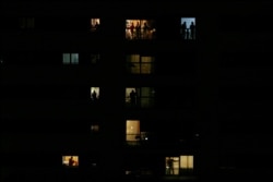 People applaud from their houses in support of the medical staff in Rivas Vaciamadrid, March 14, 2020.