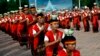 FILE - Indonesian girls put bowls of holy water on their heads as they perform a traditional dance during the opening ceremony of Lake Toba Festival on Samosir island, North Sumatra, Indonesia.