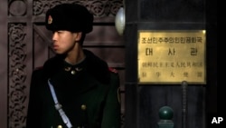 A Chinese paramilitary policeman stands guard outside the North Korean Embassy in Beijing, Jan. 6, 2016. 