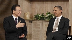 U.S. President Barack Obama meets with Chinese Premier Wen Jiabao on the sidelines of the East Asia Summit in Nusa Dua, in Bali, Indonesia, Saturday, Nov. 19, 2011.