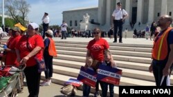 Protesters are seen in front of the U.S. Supreme Court in Washington as justices hear arguments on a citizenship question the Trump administration wants to add to the census questionnaire, April 23, 2019. 