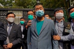 FILE - Hong Kong media tycoon and pro-democracy figure Jimmy Lai is arrested by police at his home in Hong Kong, April 18, 2020. Fourteen other activists were arrested along with him.