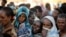 FILE - Ethiopian refugees line up for supplies at the Um Rakouba refugee camp, which houses refugees fleeing the fighting in the Tigray region, on the Sudan-Ethiopia border in Sudan, Nov. 29, 2020. 