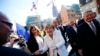 German President Joachim Gauck (R) and Chancellor Angela Merkel (C) meet wellwishers in the streets of Frankfurt, Germany, October 3, 2015. Germany's political leaders celebrate the country's 25th anniversary since the reunification of East and West Germa