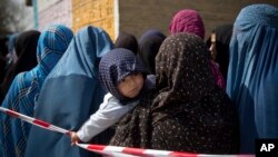 Afghan women in line queuing to get their registration cards on the last day of voter registration for the presidential elections, April 1.