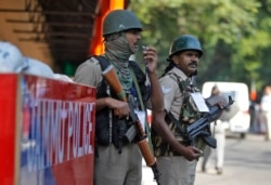 FILE - Indian security personnel guard outside the civil secretariat of the Union territory of Jammu and Kashmir during the annual reopening of the former state's winter capital in Jammu, India, Nov. 4, 2019.