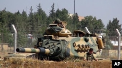 FILE - A Turkish army tank is seen near the Syrian border in Suruc, Turkey, Sept. 3, 2016. Since then, tanks have entered Syria's Cobanbey district as part of the Euphrates Shield operation to aid Syrian rebels against the Islamic State group.