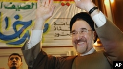 FILE - Former Iranian President Mohammad Khatami gestures as he tours Al-Azhar Mosque and University in Cairo, March 29, 2007.
