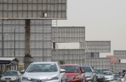 Cars drive past the blank billboards on the 6th of October Bridge, amid concerns over the coronavirus disease, in Cairo, Egypt, May 13, 2020.