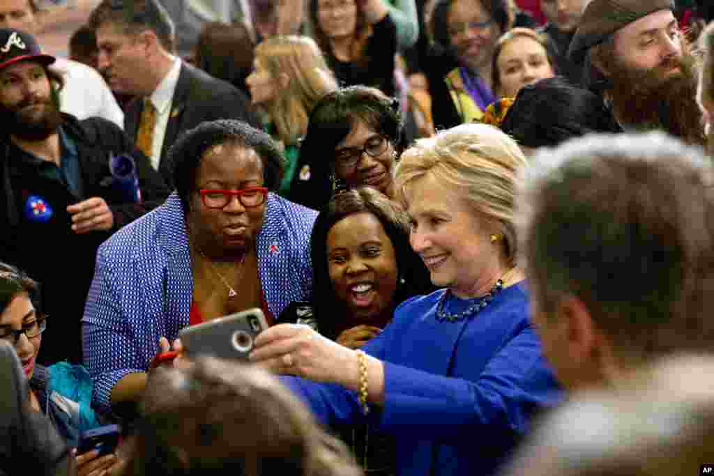 Democratic presidential candidate Hillary Clinton takes pictures with supporters after a campaign event at the Central Baptist Church in Columbia, S.C., Feb. 23, 2016.