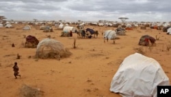 A child runs, left, at a refugee camp in Dadaab, Kenya, Aug 4, 2011.