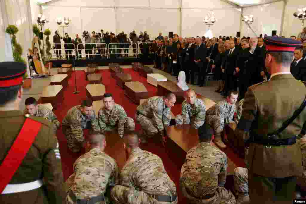 Malta soldiers carry coffins with the bodies of migrants at an interfaith burial service at Mater Dei Hospital in Tal-Qroqq, outside Valletta, April 23, 2015.