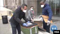 Restaurateur Luca Di Pietro (left) delivers free meals to a New York hospital. 