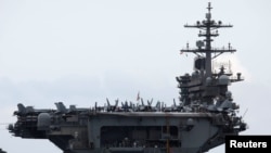 FILE - The USS Theodore Roosevelt enters the port in Da Nang, Vietnam, March 5, 2020. 