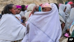 Ethiopian women gather at a community meeting in Mai Mekden, in the Tigray region of northern Ethiopia, on Feb. 27, 2024. Mothers, faces etched with worry, watch helplessly as their children weaken from malnutrition.