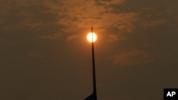 The sun, muted by smoke, is visible in Portland, Ore., Sept. 5, 2017. Dozens of fires across the Western U.S. and Canada blanketed the air with choking smoke from Oregon to Colorado, where health officials issued air quality alerts.