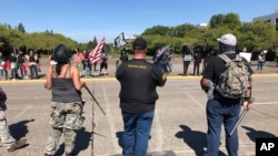 Supporters of President Donald Trump and Black Lives Matter protesters confront each other at the Oregon state Capitol in Salem, Ore., Sept. 7, 2020.