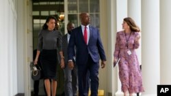 Sen. Tim Scott, R-S.C., center, arrives for an event on police reform, in the Rose Garden of the White House, June 16, 2020, in Washington. 
