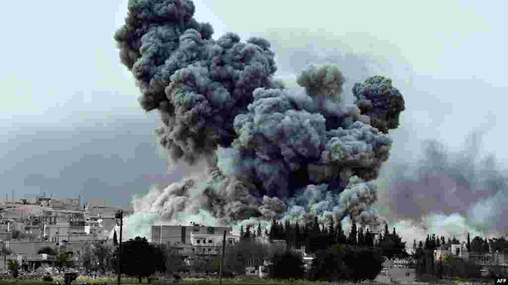 Smoke rises after a strike on the Syrian town of Ain al-Arab, known as Kobani by the Kurds, as seen from the Turkish-Syrian border, in the southeastern village of Mursitpinar, Sanliurfa province, on Oct. 12, 2014. 