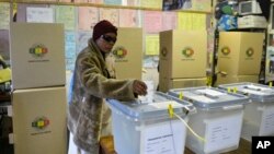 FILE - A woman casts her vote in elections in Mbare, Harare, Zimbabwe, July 31, 2013.