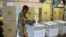 FILE - A woman casts her vote in elections in Mbare, Harare, Zimbabwe, July 31, 2013.