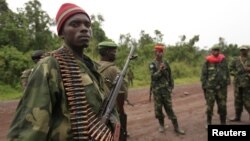 M23 rebel fighters occupy Rumangabo, after government troops abandoned the town, 23km north of the eastern Congolese city of Goma, July 28, 2012. 