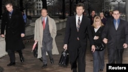 FILE - Two Blackwater guards (L & R) leave the federal courthouse in Washington with their legal team and supporters after being arraigned in a 2007 shooting in Baghdad, January 6, 2009.