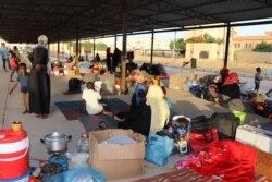 Kicked out of temporary housing, these families are camping outside. With no prospects of finding more permanent homes, many say they will still try to get to Europe, in Tripoli, Libya, July 2, 2019. (H. Murdock/VOA)