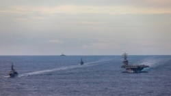 FILE - Japan Maritime Self-Defense Force training ships JS Kashima and JS Shimayuki conduct a passing exercise (PASSEX) with Nimitz-class nuclear-powered aircraft carrier USS Ronald Reagan in the South China Sea, July 7, 2020.