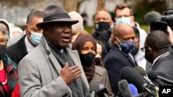 Ben Crump, left, the attorney representing George Floyd's family, speaks outside of the Hennepin County Government Center in Minneapolis on April 19, 2021, before the murder trial against former police officer Derek Chauvin advances to jury deliberations.