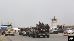 Iraqi security forces and Shi'ite militiamen prepare to attack Islamic State extremists in Tikrit, 130 kilometers (80 miles) north of Baghdad, March 13, 2015. 