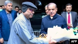 Pakistan's newly sworn-in Prime Minister Shehbaz Sharif, second from right, greets newly elected President Asif Ali Zardari, fourth from right, in Islamabad on March 9, 2024. (Pakistan's Press Information Department via AFP)