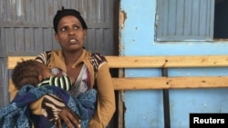 A woman breastfeeds her child at the Halo health post in Halo village, a drought-stricken area in Oromia region in Ethiopia, Jan. 31, 2016.
